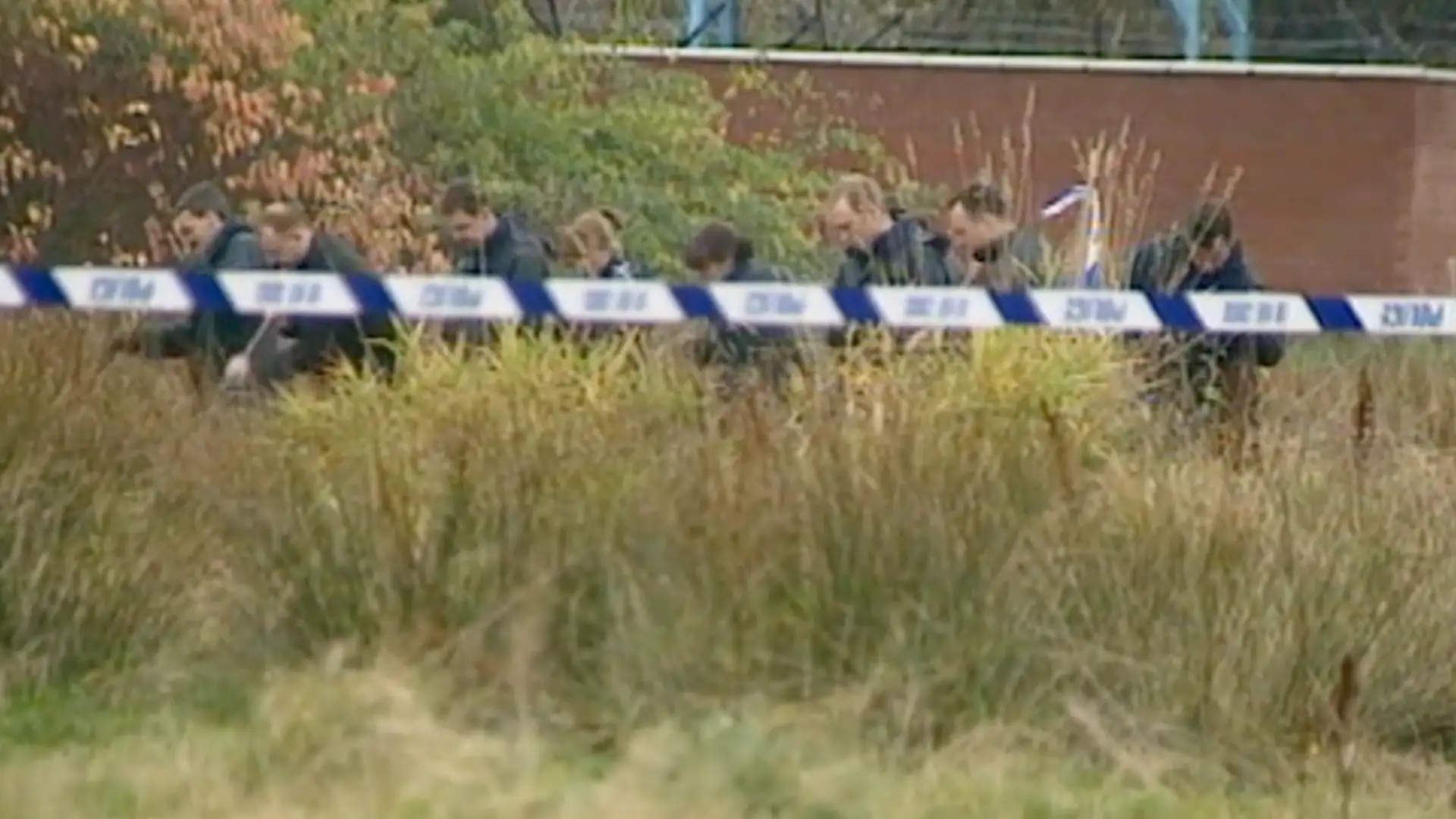 Police officers searching a field near the Shona Stevens crime scene